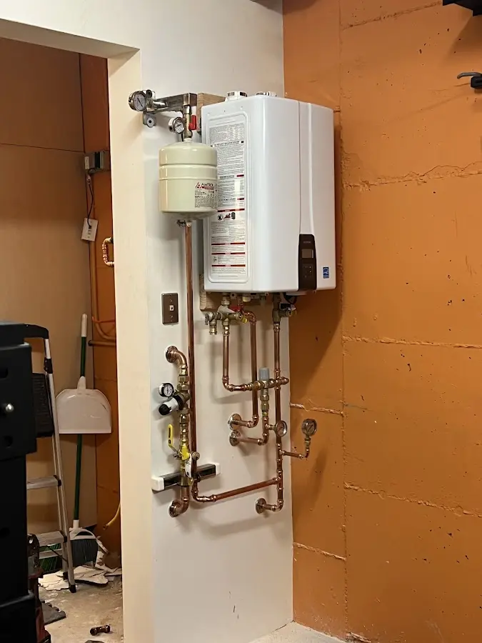 Plumbing technician inspecting water heater connections in Indian Harbour Beach